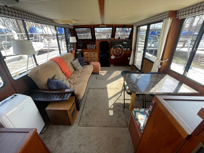 Slide: The Image of Interior of 1984 Bluewater 42 Coastal Cruiser with cozy seating and helm. - 28