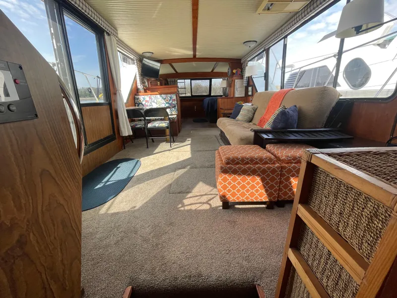Slide: The Image of Interior of 1984 Bluewater 42 Coastal Cruiser, featuring cozy seating and large windows. - 29