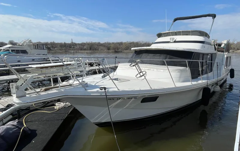 Slide: The Image of 1984 Bluewater 42 Coastal Cruiser docked at marina, featuring sleek white design. - 3