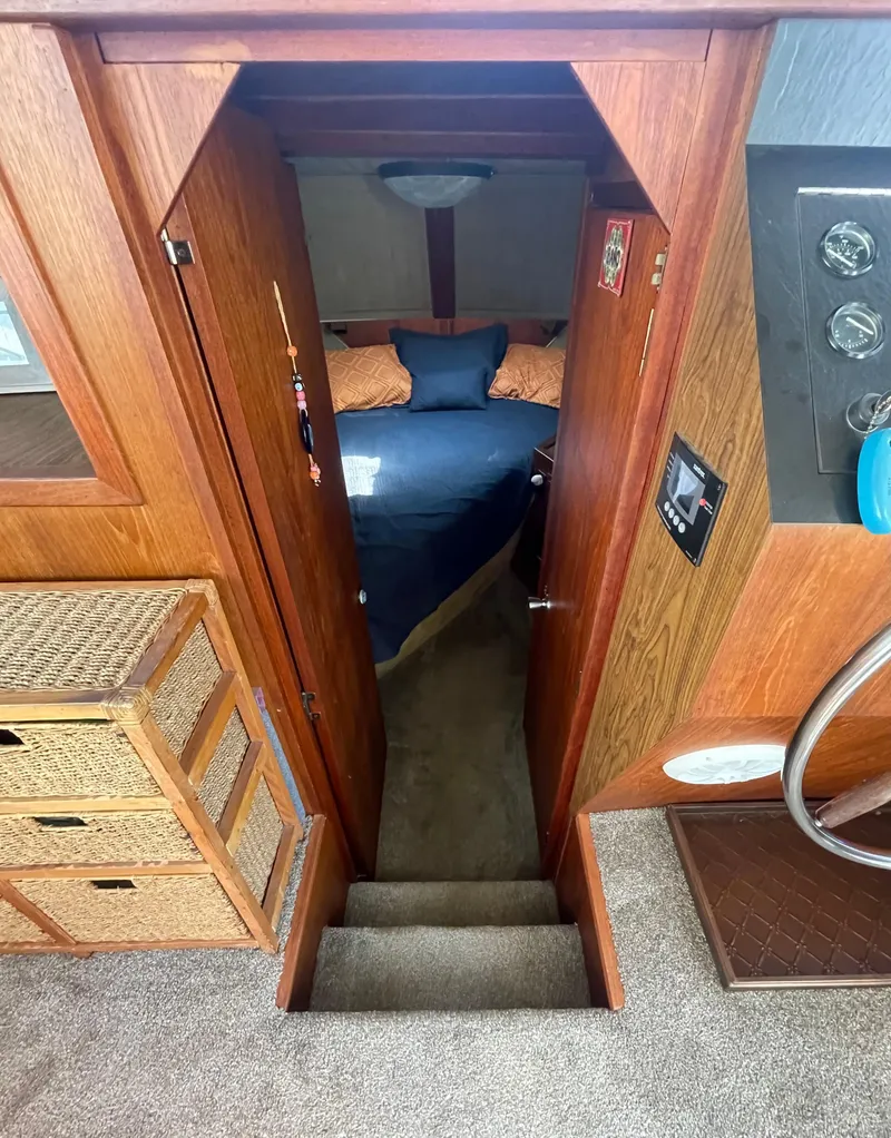 Slide: The Image of Interior view of 1984 Bluewater 42 Coastal Cruiser, featuring cozy cabin and wooden accents. - 30