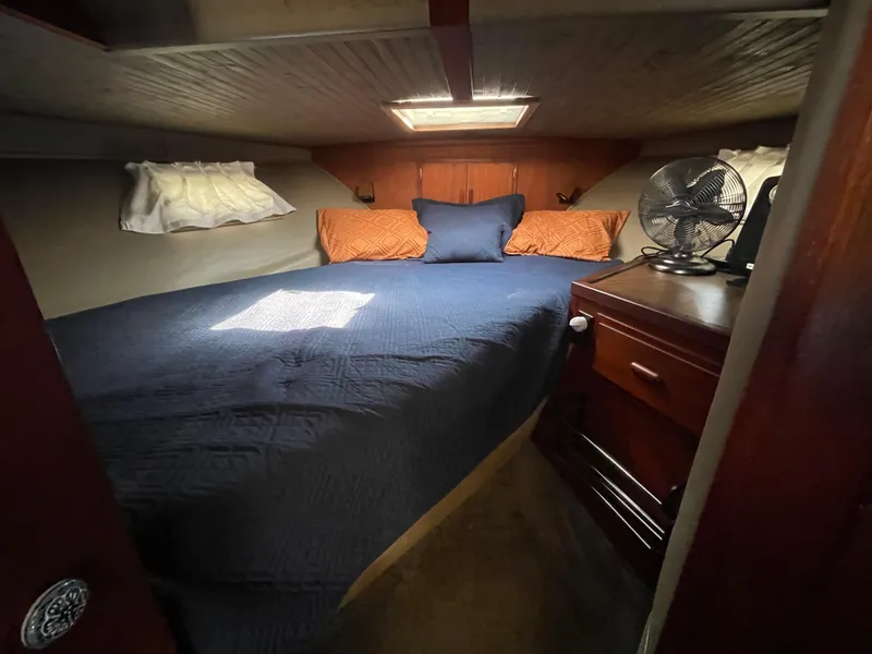 Slide: The Image of Cozy cabin interior of 1984 Bluewater 42 Coastal Cruiser with bed and fan. - 31