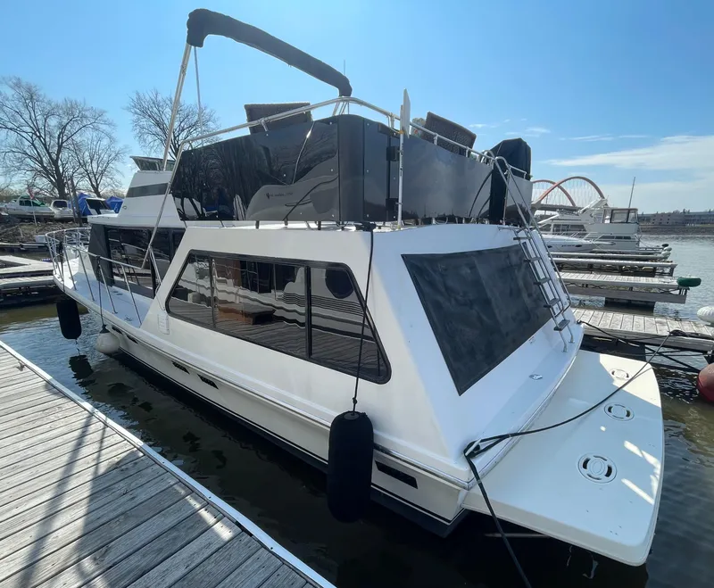 Slide: The Image of 1984 Bluewater 42 Coastal Cruiser docked at a marina, featuring sleek design and spacious deck. - 4
