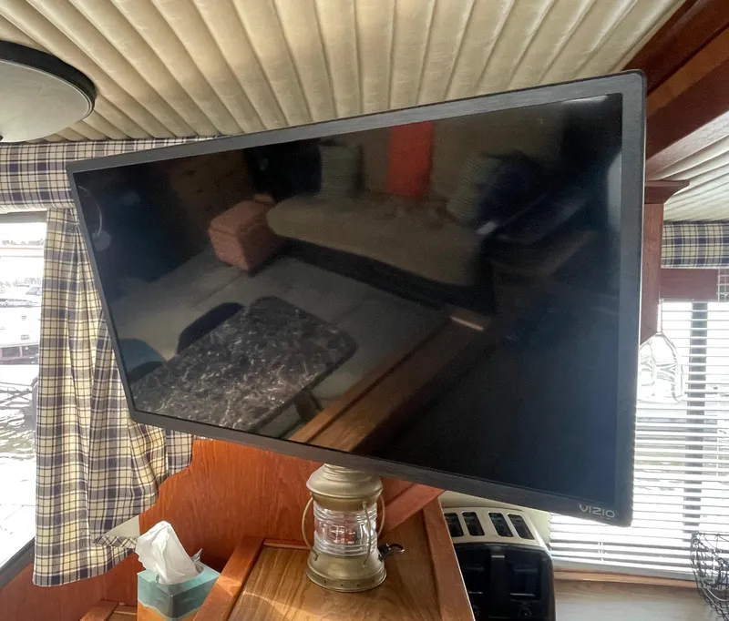 Slide: The Image of Flat-screen TV inside 1984 Bluewater 42 Coastal Cruiser boat, with nautical decor. - 43