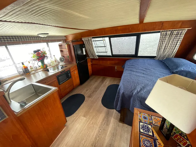 Slide: The Image of Interior of 1984 Bluewater 42 Coastal Cruiser with kitchen and bed, featuring wood finishes. - 47