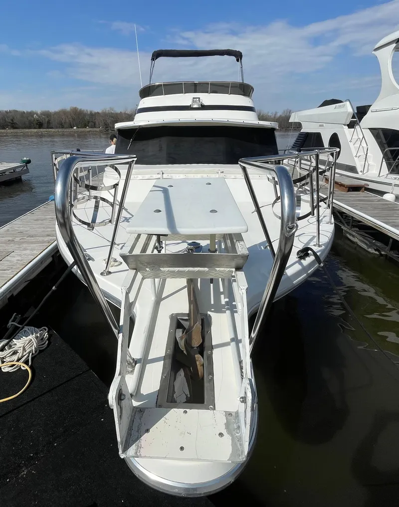 Slide: The Image of 1984 Bluewater 42 Coastal Cruiser docked, showcasing sleek design and spacious deck. - 5