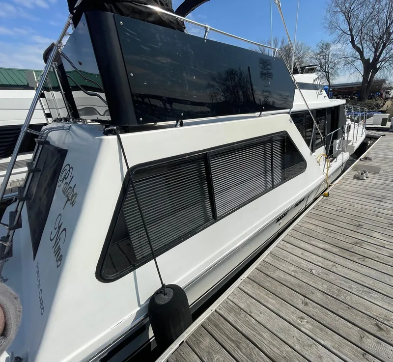 Slide: The Image of 1984 Bluewater 42 Coastal Cruiser docked, showcasing sleek design and spacious windows. - 8