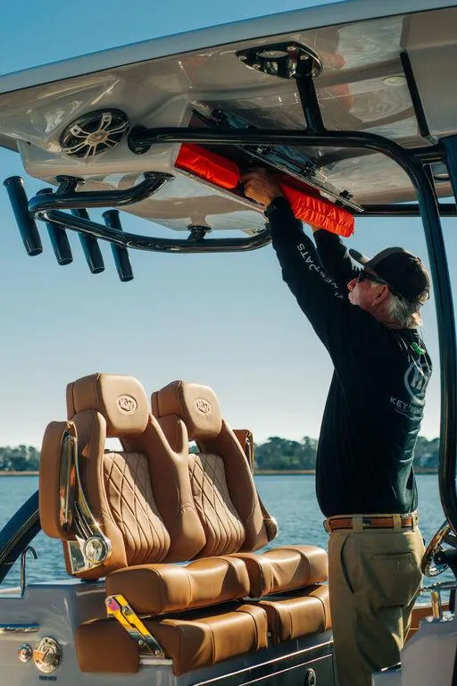 Slide: The Image of Man organizing gear on 2025 Key West 239FSR boat with luxurious seating. - 14