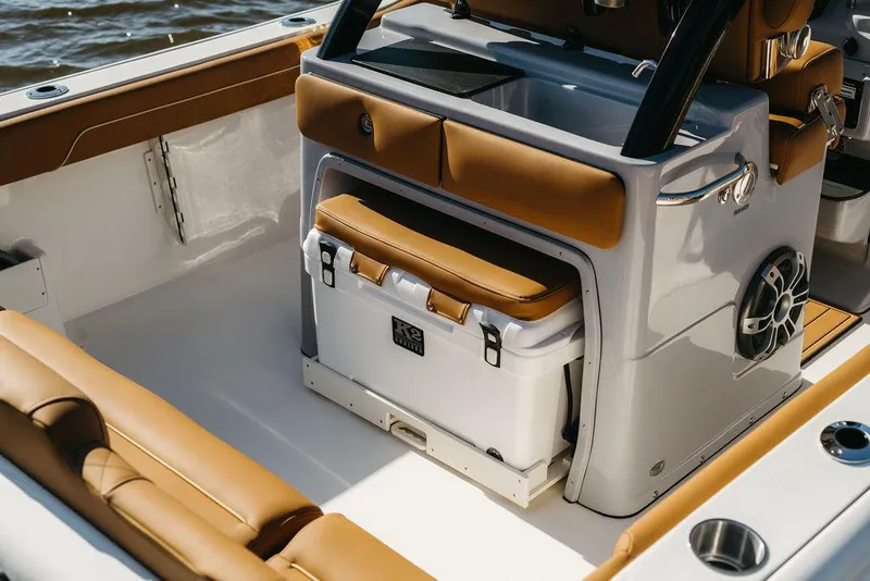 Slide: The Image of 2025 Key West 239FSR boat interior with tan seating and built-in cooler. - 16