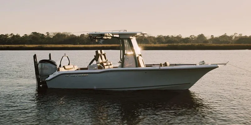 Slide: The Image of 2025 Key West 239FSR boat on calm water at sunset. - 3