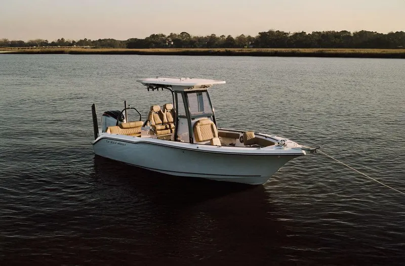 Slide: The Image of 2025 Key West 239FSR boat on calm water at sunset. - 4