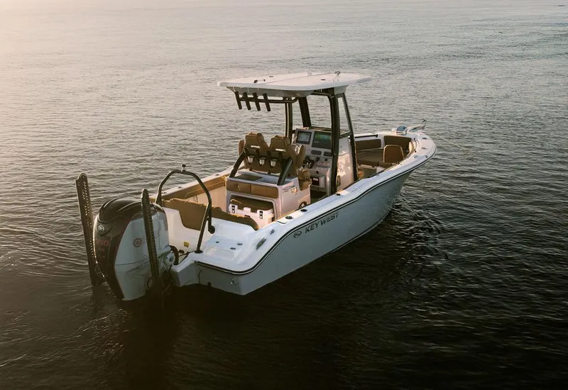 Slide: The Image of 2025 Key West 239FSR boat on calm water at sunset. - 6