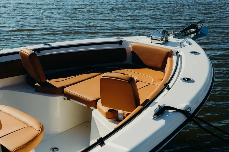 Slide: The Image of 2025 Key West 239FSR boat with tan seating on calm water. - 7