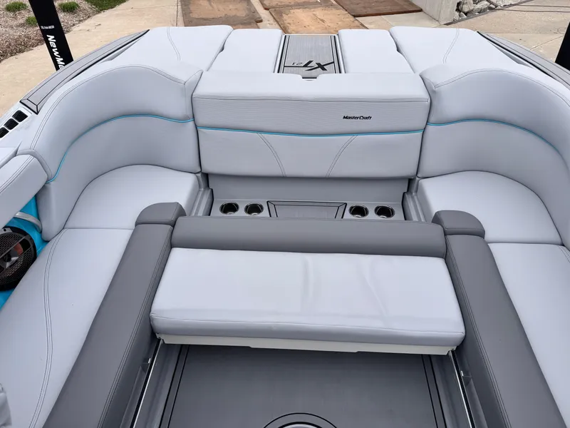 Slide: The Image of 2022 MasterCraft XT21 boat interior with white and gray seating, cup holders, and sleek design. - 12