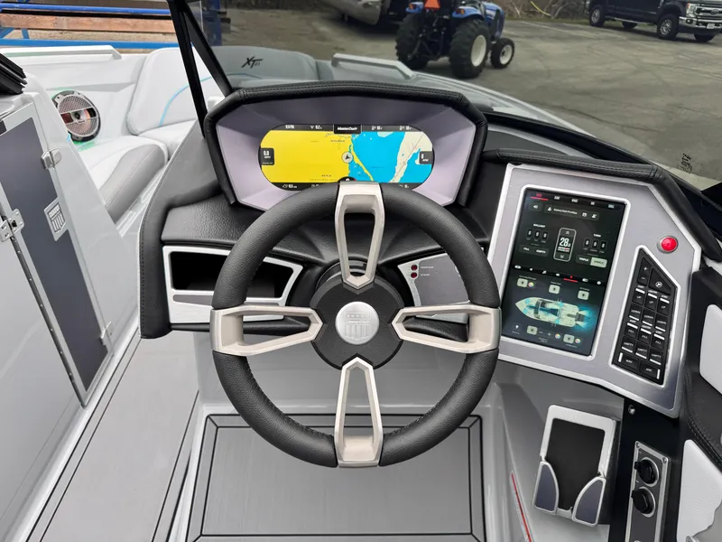 Slide: The Image of 2022 MasterCraft XT21 boat dashboard with steering wheel and digital display. - 14