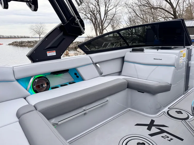 Slide: The Image of 2022 MasterCraft XT21 boat interior with sleek seating and modern design. - 18
