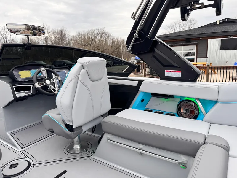 Slide: The Image of 2022 MasterCraft XT21 boat interior with modern seating and dashboard design. - 19