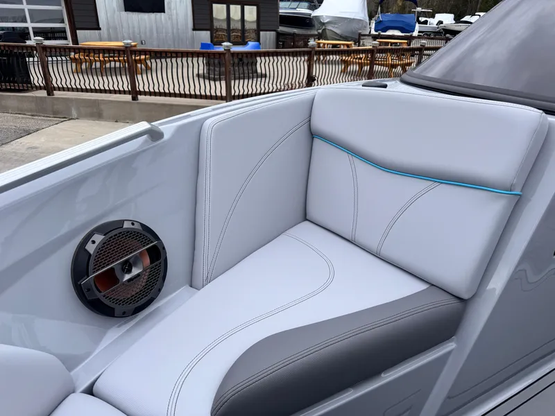 Slide: The Image of 2022 MasterCraft XT21 boat interior with sleek seating and built-in speaker. - 22