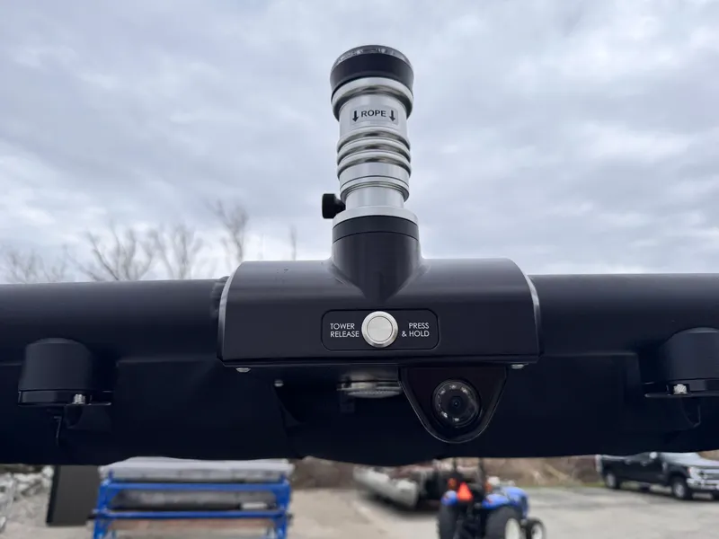 Slide: The Image of 2022 MasterCraft XT21 boat tower with tow point and camera, under cloudy sky. - 23