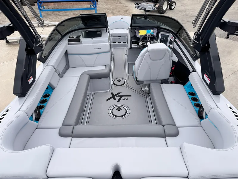 Slide: The Image of 2022 MasterCraft XT21 boat interior with sleek seating and modern dashboard. - 7