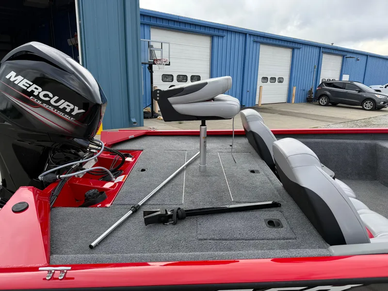 Slide: The Image of 2016 Tracker Pro Team 175 TXW boat with Mercury engine, gray seating, and red exterior. - 4