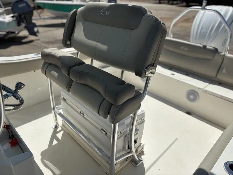 Slide: The Image of 2022 Key West 239FS boat seat with cushioned backrest and storage compartment. - 12