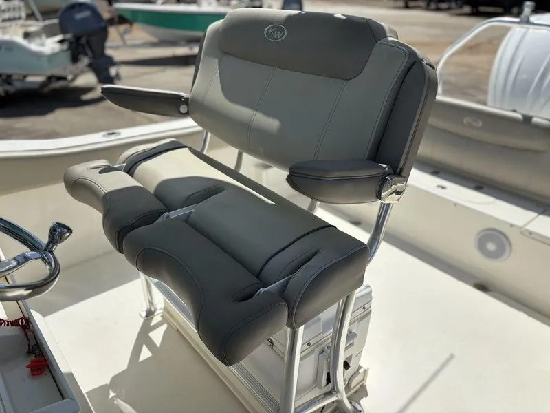 Slide: The Image of 2022 Key West 239FS boat seat with cushioned armrests and sleek design. - 13