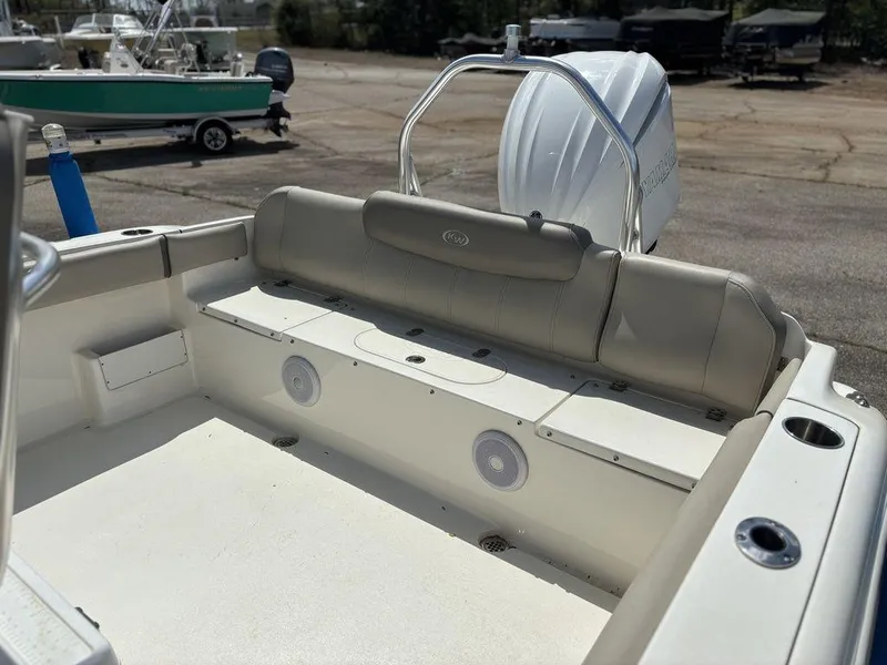 Slide: The Image of 2022 Key West 239FS boat interior with cushioned seating and motor view. - 14