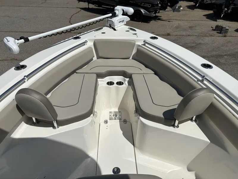 Slide: The Image of 2022 Key West 239FS boat interior with cushioned seating and trolling motor. - 17