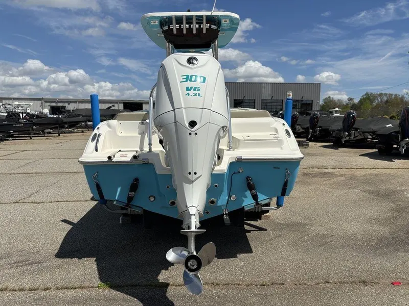 Slide: The Image of 2022 Key West 239FS boat with powerful outboard motor, parked outdoors under a clear sky. - 5