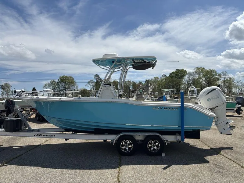 Slide: The Image of 2022 Key West 239FS boat on trailer, light blue hull, parked outdoors. - 6
