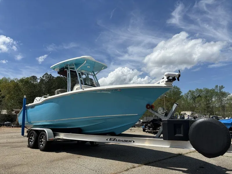 Slide: The Image of 2022 Key West 239FS boat on trailer under blue sky. - 7