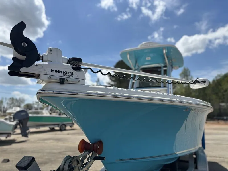 Slide: The Image of 2022 Key West 239FS boat with Minn Kota trolling motor under a blue sky. - 8
