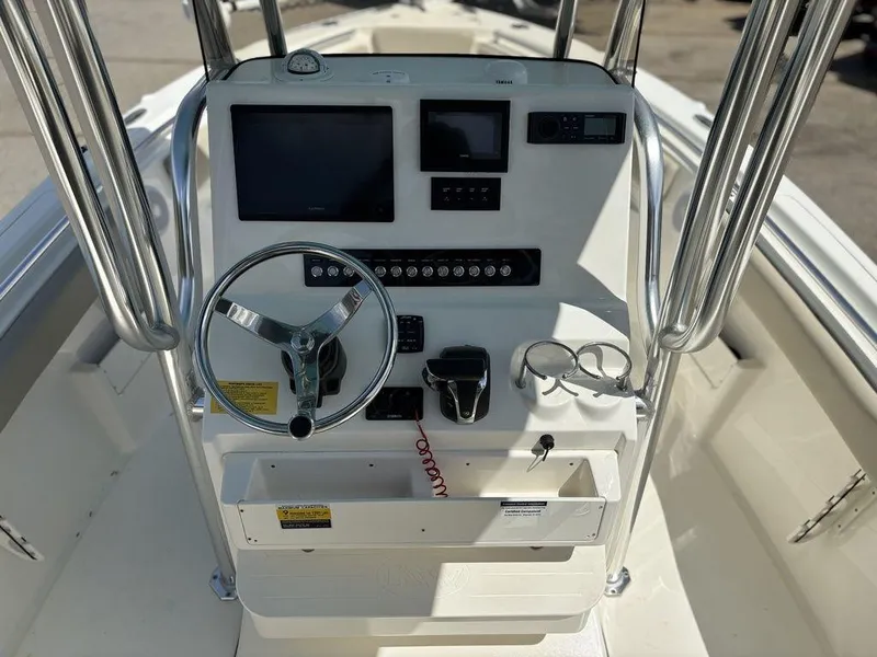 Slide: The Image of 2022 Key West 239FS boat console with steering wheel, gauges, and controls. - 9