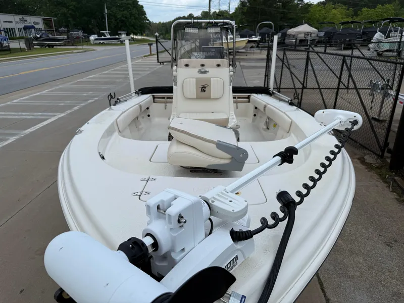 Slide: The Image of 2015 Carolina Skiff 19 Sea Skiff boat with trolling motor, parked on a concrete surface. - 10