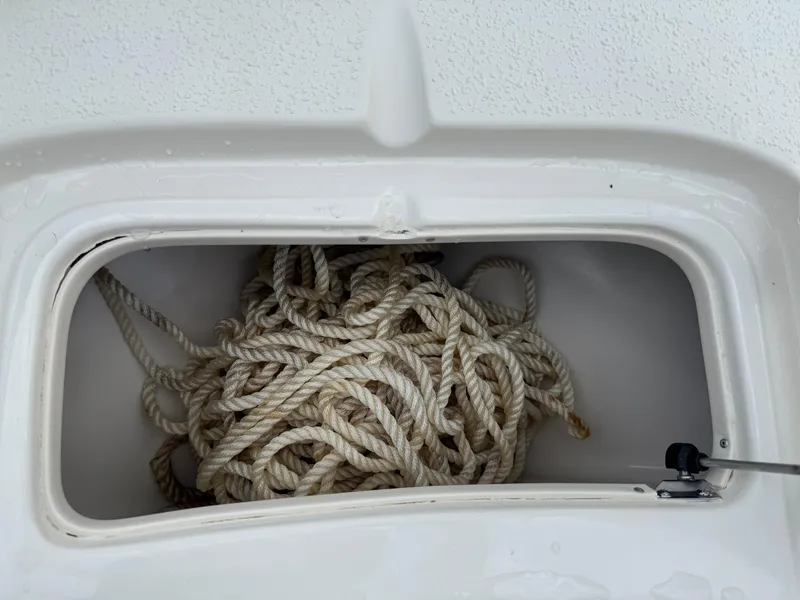 Slide: The Image of Storage compartment with rope on a 2015 Carolina Skiff 19 Sea Skiff boat. - 17