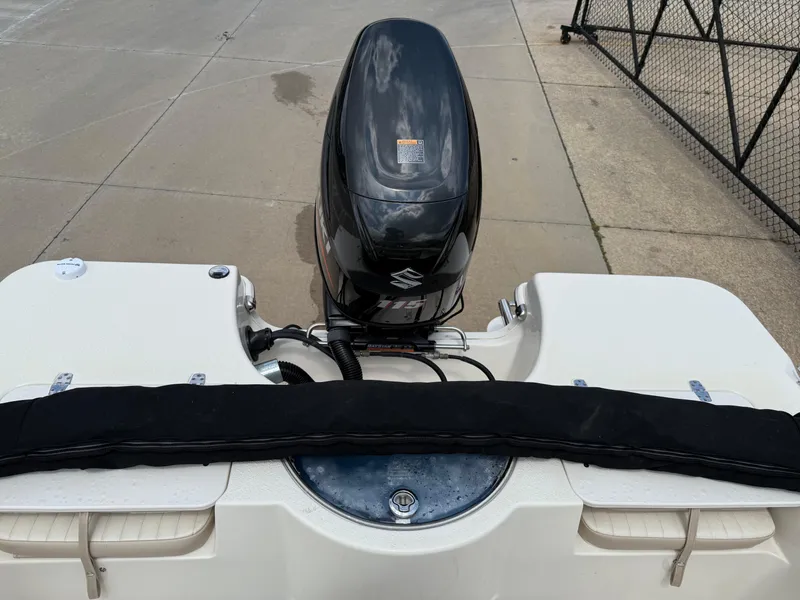 Slide: The Image of 2015 Carolina Skiff 19 Sea Skiff with Suzuki outboard motor, docked on concrete. - 21