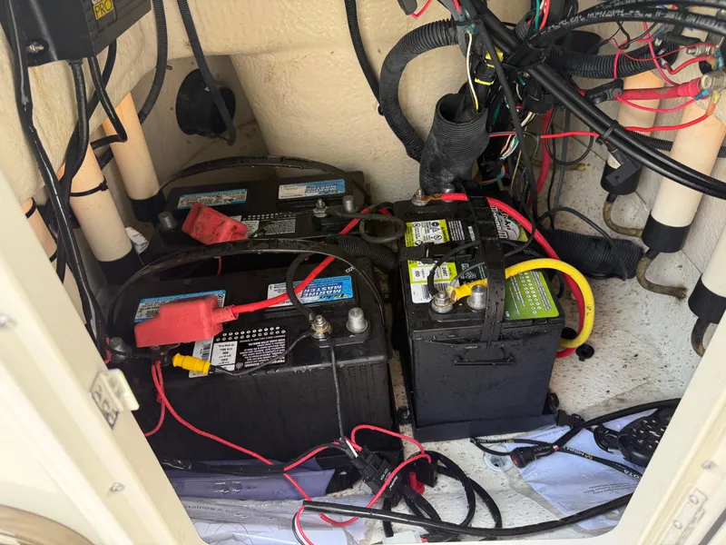 Slide: The Image of 2015 Carolina Skiff 19 Sea Skiff battery compartment with wiring and connections. - 23