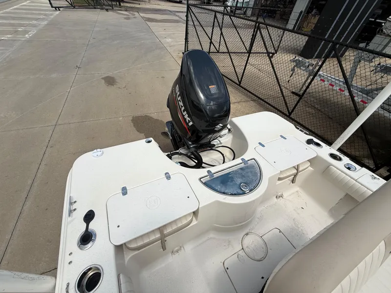 Slide: The Image of 2015 Carolina Skiff 19 Sea Skiff boat with outboard motor, docked on concrete surface. - 25