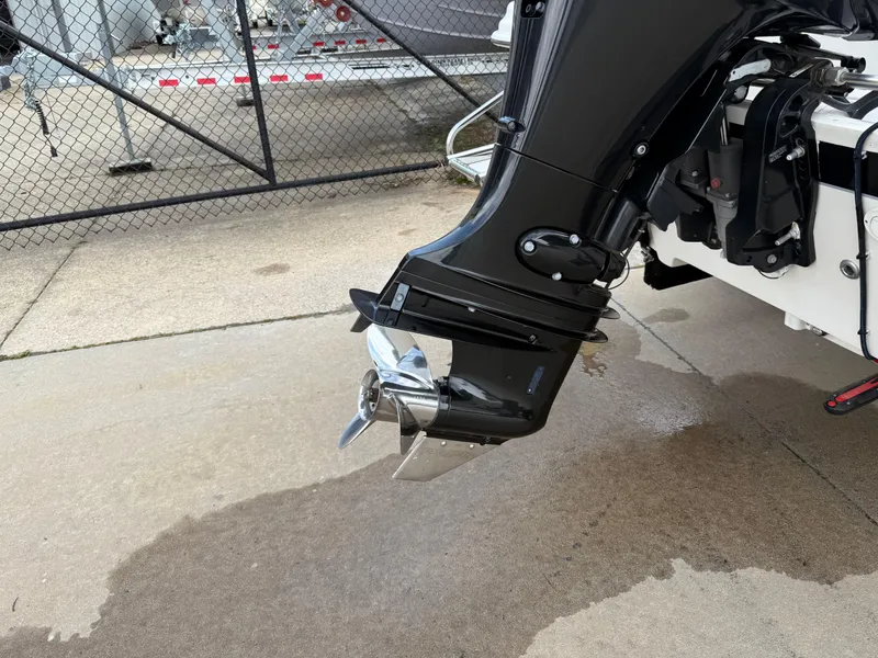 Slide: The Image of Outboard motor of a 2015 Carolina Skiff 19 Sea Skiff on a wet concrete surface. - 33