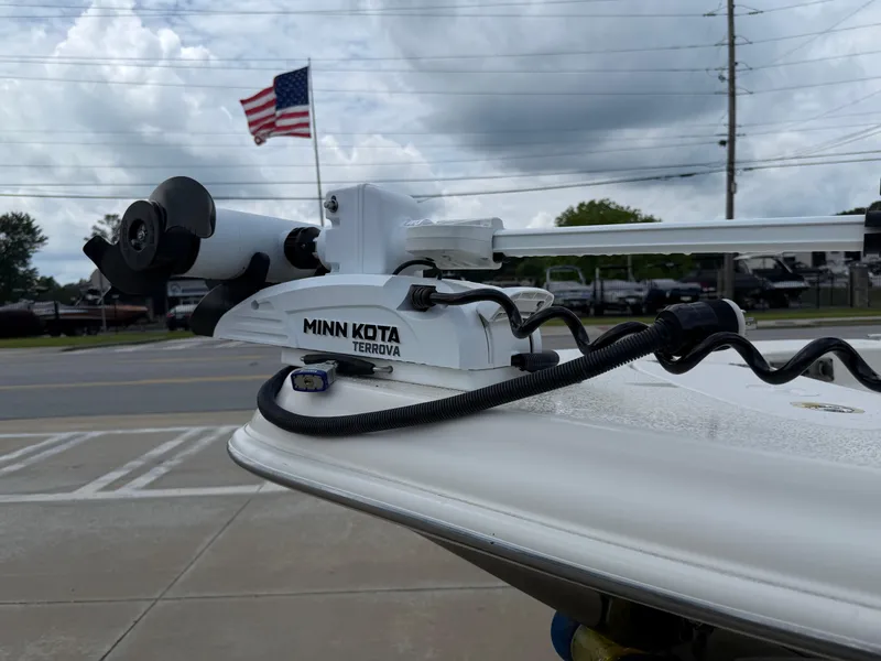 Slide: The Image of 2015 Carolina Skiff 19 Sea Skiff with Minn Kota Terrova motor, American flag in background. - 36