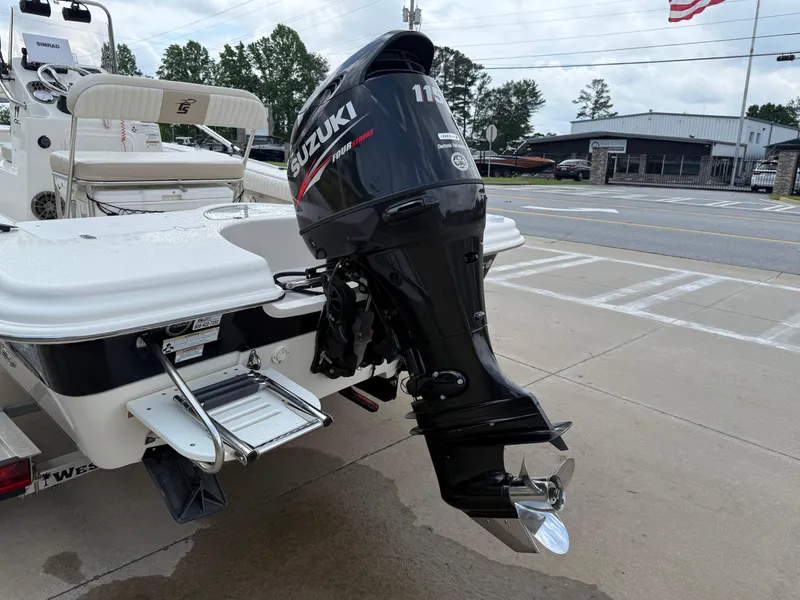 Slide: The Image of 2015 Carolina Skiff 19 Sea Skiff with Suzuki outboard motor, parked on pavement. - 37
