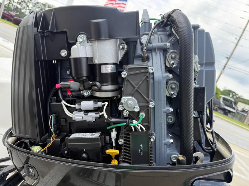 Slide: The Image of Close-up of a 2015 Carolina Skiff 19 Sea Skiff outboard motor, showcasing engine components. - 38