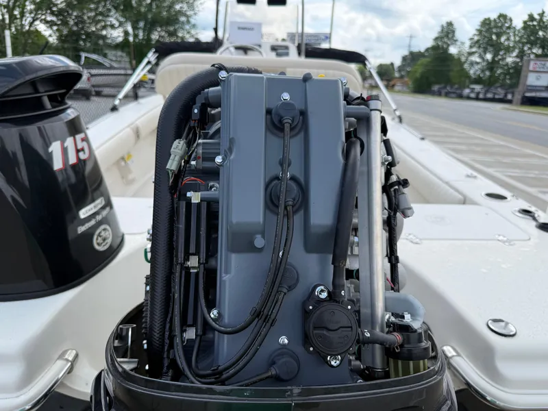 Slide: The Image of 2015 Carolina Skiff 19 Sea Skiff with exposed outboard engine, parked outdoors. - 39