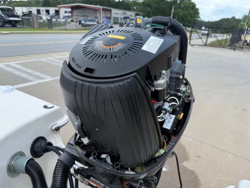 Slide: The Image of Outboard motor of a 2015 Carolina Skiff 19 Sea Skiff, parked near a road. - 41