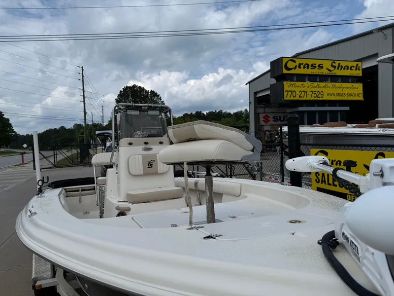 Slide: The Image of 2015 Carolina Skiff 19 Sea Skiff boat displayed at dealership, overcast sky. - 45