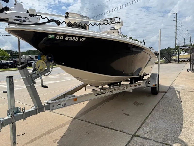 Slide: The Image of 2015 Carolina Skiff 19 Sea Skiff on trailer, parked outdoors, overcast sky. - 7