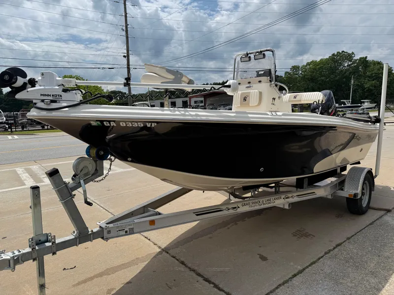 Slide: The Image of 2015 Carolina Skiff 19 Sea Skiff on trailer, parked outdoors under cloudy sky. - 8