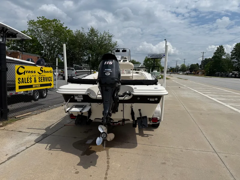 Slide: The Image of 2015 Carolina Skiff 19 Sea Skiff with outboard motor, parked near sales and service shop. - 9