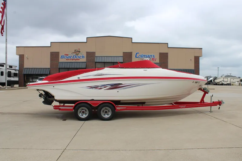 Slide: The Image of 2007 Rinker 246 Captiva Bowrider on red trailer, parked outside dealership. - 0