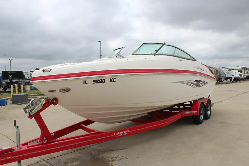 Slide: The Image of 2007 Rinker 246 Captiva Bowrider on red trailer, parked outdoors. - 10